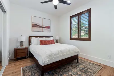 a white bedroom with a bed and a window at Luxury Escondido Family Oasis with Hot Tub in Escondido