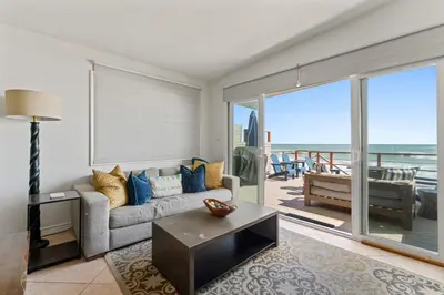 a living room with a couch and a view of the ocean at Private beach toes on the Sand Waterworld in Dana Point