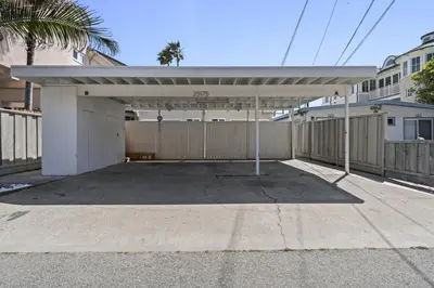 a large white garage with a roof at Private beach toes on the Sand Waterworld in Dana Point