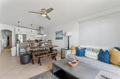 a living room with a couch and a table at Private beach toes on the Sand Waterworld in Dana Point