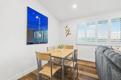 a dining room with a table and chairs and a couch at Dog-Friendly House with Hot Tub, AC, Game Room in Oceanside