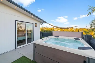 a hot tub on the patio of a house at Dog-Friendly House with Hot Tub, AC, Game Room in Oceanside