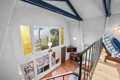 an attic room with a staircase and windows at The SeaBarn Vista Views, Hot Tub and Stargazing in San Diego
