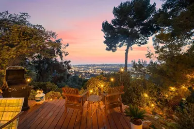 a deck with chairs and a grill at sunset at The SeaBarn Vista Views, Hot Tub and Stargazing in San Diego