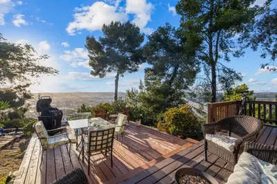 a deck with chairs and a table and a grill at The SeaBarn Vista Views, Hot Tub and Stargazing in San Diego