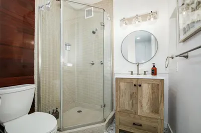 a bathroom with a shower and a toilet and a sink at Beachfront Bliss Cozy 1BR Condo with Shared Perks in San Diego