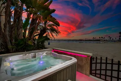 a hot tub on the beach with a sunset at Bayfront Beauty 3BR Mission Bay Retreat in San Diego