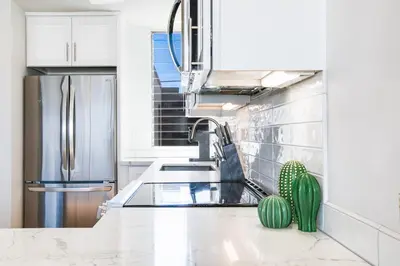 a kitchen with a sink and a refrigerator at Bayfront Beauty 3BR Mission Bay Retreat in San Diego