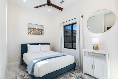a bedroom with a bed and a mirror at Inviting 3BR Space with Firepit in San Clemente