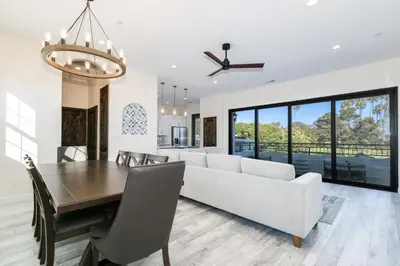 a dining room and living room with a couch and a table at Inviting 3BR Space with Firepit in San Clemente