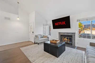 a living room with a tv and a fireplace at Spacious 4BR Oasis with Pool Table and Spa in San Diego