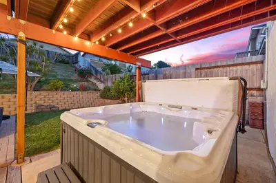 a large bath tub sitting on a patio at Spacious 4BR Oasis with Pool Table and Spa in San Diego