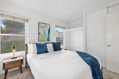 a white bedroom with a bed and a window at Spacious 4BR Oasis with Pool Table and Spa in San Diego