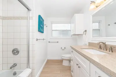 a white bathroom with a shower and a toilet at 4Br Coastal Home W Oceanview Patio, Close To The Beach By Beachview Rentals in Newport Beach