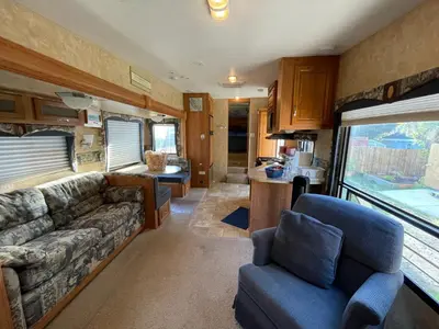 a living room and kitchen of an rv at La Mesa Cozy Camper in San Diego