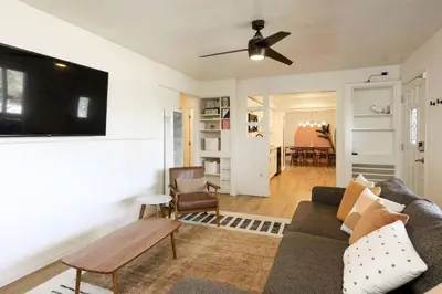 a living room with a couch and a flat screen tv at Casa Ciela, AC,Spa,15 min Downtown, Beach, Theatre in San Diego