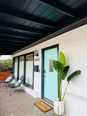 a porch with two chairs and a blue door at Casa Ciela, AC,Spa,15 min Downtown, Beach, Theatre in San Diego