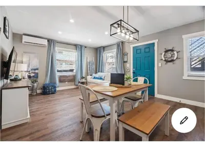 a dining room with a table and a blue door at #753Coastal Anchor Suite!GroundLevel/Parking/Grill in San Diego