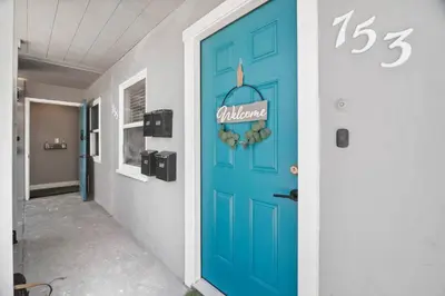 a blue door in a hallway with a sign on it at #753Coastal Anchor Suite!GroundLevel/Parking/Grill in San Diego