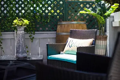 a patio with a chair and a table with a vase at #763 Steps from the Sand -2b2b Laundry Parking AC in San Diego