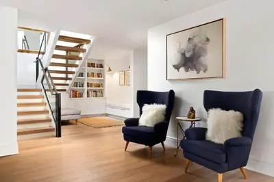 a living room with two chairs and a staircase at Modern Coastal La Jolla Gem in San Diego