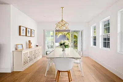 a dining room with a table and a vase of flowers at Modern Coastal La Jolla Gem in San Diego