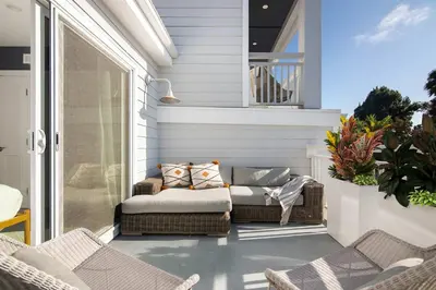a porch with a couch and chairs on a balcony at Modern Coastal La Jolla Gem in San Diego