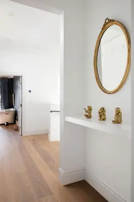 a living room with a mirror on a wall at Modern Coastal La Jolla Gem in San Diego