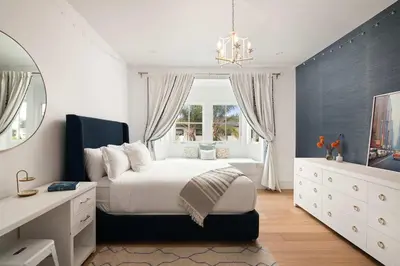 a bedroom with a bed and a dresser and a window at Modern Coastal La Jolla Gem in San Diego