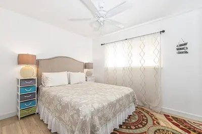 a bedroom with a bed and a ceiling fan at 3Br Oceanview Corner Retreat One House From The Beach By Beachview Rentals in Newport Beach
