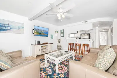 a living room with a couch and a table at 3Br Oceanview Corner Retreat One House From The Beach By Beachview Rentals in Newport Beach