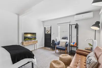 a bedroom with a bed and a living room at Balboa Island Cottage Air Conditioning Ferry Close in Newport Beach