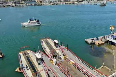 a boat is docked at a dock in the water at Balboa Island Cottage Air Conditioning Newport Peninsula Ferry Close in Newport Beach