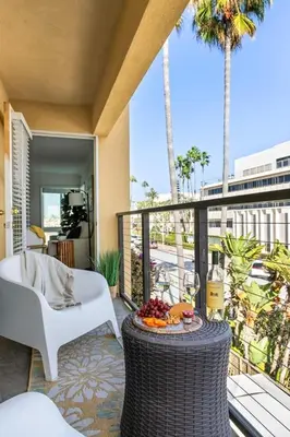 a balcony with a table with fruit on it at Seize the Day in San Diego