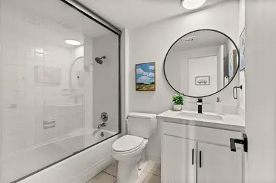 a bathroom with a toilet and a sink and a mirror at Seize the Day in San Diego