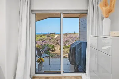 a room with a window with a view of the ocean at Surf Song Symphony - SONG55 in Solana Beach