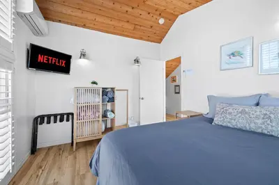 a bedroom with a bed and a sign on the wall at Mission Beach 3BR Gem Rooftop Patio and Hot Tub in San Diego