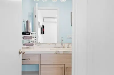a bathroom with a sink and a mirror at Mission Beach 3BR Gem Rooftop Patio and Hot Tub in San Diego