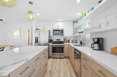 a kitchen with white counter tops and wooden cabinets at Mission Beach 3BR Gem Rooftop Patio and Hot Tub in San Diego