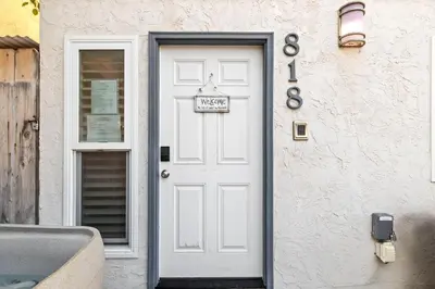 a white door with a welcome sign on it at Mission Beach 3BR Gem Rooftop Patio and Hot Tub in San Diego