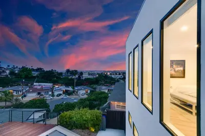 a view from the balcony of a house with a sunset at Luxury Pool Haven Scenic Views and Summer Fireworks in San Diego