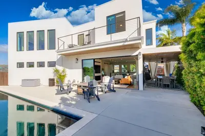 a white house with a patio and a swimming pool at Luxury Pool Haven Scenic Views and Summer Fireworks in San Diego