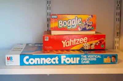 a stack of games on a shelf at Chic Retreat Ping Pong, Bonfires and Patio Leisure in San Diego