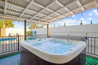 a large bath tub sitting under a pergola at Serene Sanctuary Pool, Hot Tub and Game Room in San Diego