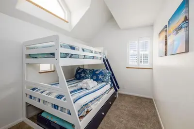 a white bunk bed in a white room at Steps From the Beach & Belmont in San Diego