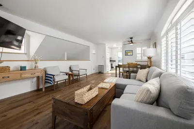 a living room with a couch and a table at Steps From the Beach & Belmont in San Diego