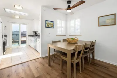 a kitchen and dining room with a table and chairs at Steps From the Beach & Belmont in San Diego