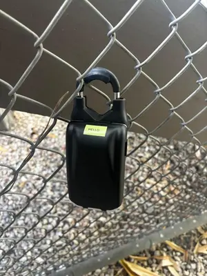 a black object is hanging on a fence at Ocean View Loft in Little Italy near Downtown-Gaslamp in San Diego