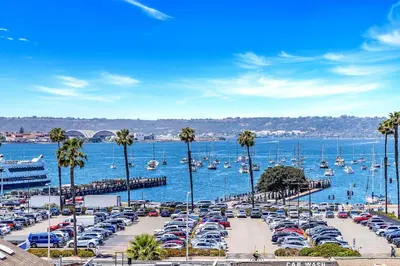 a bunch of cars parked in a parking lot next to a harbor at Ocean View Loft in Little Italy near Downtown-Gaslamp in San Diego