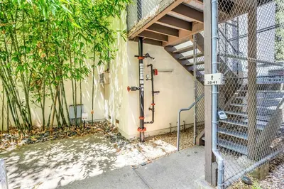 a building with a staircase next to a fence at Ocean View Loft in Little Italy near Downtown-Gaslamp in San Diego